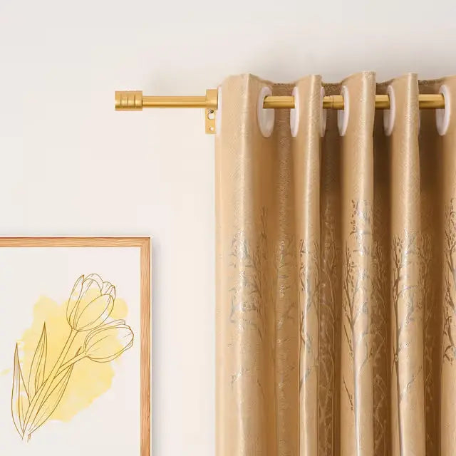 Gold extendable curtain pole fitted with curtains in a modern room